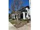 Townhome showcases a covered porch, glass-railed balcony, and a professionally landscaped front yard at 14129 Walcott Ave, Orlando, FL 32827