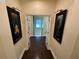 Hallway with dark wood floors, decorative lighting and artwork at 14129 Walcott Ave, Orlando, FL 32827