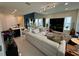 Bright, open-concept living room featuring modern furnishings, tile flooring, and an adjacent dining area at 14129 Walcott Ave, Orlando, FL 32827