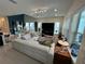 Bright living room with tile flooring, modern furnishings, large windows, and open floor plan at 14129 Walcott Ave, Orlando, FL 32827