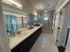 Spa-like main bathroom with double vanity, walk-in shower, and modern lighting at 14129 Walcott Ave, Orlando, FL 32827
