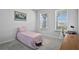 Bedroom with two windows providing natural light, and complemented by a classic desk and a pink bed at 14419 Topaghan Way, Winter Garden, FL 34787
