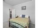 Cozy bedroom with an iron bed frame, light walls, carpet, and a door leading to other rooms at 14419 Topaghan Way, Winter Garden, FL 34787