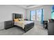 Bright bedroom with carpet floors, a black dresser, and blue curtains at 14419 Topaghan Way, Winter Garden, FL 34787
