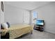 Bright bedroom with a light yellow cover, complemented by a modern TV set for added entertainment at 14419 Topaghan Way, Winter Garden, FL 34787
