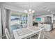 Dining room with chandelier, tile flooring, and sliding glass door to the outdoor patio at 14419 Topaghan Way, Winter Garden, FL 34787