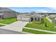 Beautiful home with a manicured lawn, 2-car garage, and charming front porch, perfect for relaxing at 14419 Topaghan Way, Winter Garden, FL 34787