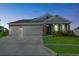 Charming single Gathering home with a well manicured lawn and 2-car garage at dusk at 14419 Topaghan Way, Winter Garden, FL 34787