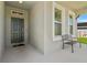 View of front door and window with bench on a charming covered porch at 14419 Topaghan Way, Winter Garden, FL 34787