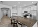 Bright kitchen features granite counters, stainless steel appliances, and white cabinets at 14419 Topaghan Way, Winter Garden, FL 34787