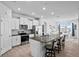 Open concept kitchen featuring a large island, modern appliances, and stylish white cabinetry at 14419 Topaghan Way, Winter Garden, FL 34787