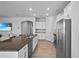 Open kitchen with stainless steel refrigerator and granite countertop island at 14419 Topaghan Way, Winter Garden, FL 34787