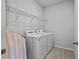 Laundry area featuring a modern washer and dryer set, with a wire shelf for added storage space at 14419 Topaghan Way, Winter Garden, FL 34787