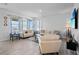 Elegant living room with ample natural light, neutral tones, and comfortable seating arrangement at 14419 Topaghan Way, Winter Garden, FL 34787