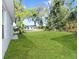 Lush backyard featuring a sprawling green lawn, and well-manicured landscaping at 1449 Monte Carlo Trl, Orlando, FL 32805