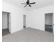 Spacious bedroom featuring a ceiling fan and two entryways to bathroom and closet at 1449 Monte Carlo Trl, Orlando, FL 32805