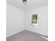 Bedroom featuring gray carpet, white walls, and a window with exterior view at 1449 Monte Carlo Trl, Orlando, FL 32805