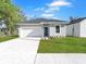 Charming single-Gathering home featuring a well-manicured lawn and an attached one-car garage at 1449 Monte Carlo Trl, Orlando, FL 32805