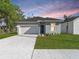Charming single-Gathering home featuring a well-manicured lawn and an attached one-car garage at 1449 Monte Carlo Trl, Orlando, FL 32805