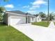 Single-Gathering home featuring a well-manicured lawn, long driveway and an attached one-car garage at 1449 Monte Carlo Trl, Orlando, FL 32805
