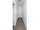 Hallway featuring white walls, light wood-look flooring and two doors on the left at 1449 Monte Carlo Trl, Orlando, FL 32805