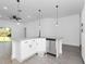 White kitchen features granite countertops, modern appliances, and a large island with a sink at 1449 Monte Carlo Trl, Orlando, FL 32805