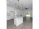 Bright kitchen features modern appliances, gray tile floors, granite counters, and a large island at 1449 Monte Carlo Trl, Orlando, FL 32805