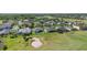 Aerial view of a neighborhood near a golf course and lake, showcasing well-maintained homes and landscaping at 213 Strathmore Cir, Kissimmee, FL 34744