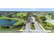 Community aerial view showcasing lush green golf course, a serene lake, and beautiful homes at 213 Strathmore Cir, Kissimmee, FL 34744