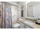 Bright bathroom with granite vanity, shower-tub combo, and nautical-themed decorations at 213 Strathmore Cir, Kissimmee, FL 34744