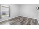 Cozy bedroom features a window that lets in ample natural light and wood-look flooring at 213 Strathmore Cir, Kissimmee, FL 34744
