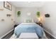 Cozy bedroom with a comfortable bed, cat decor and a ceiling fan at 213 Strathmore Cir, Kissimmee, FL 34744