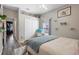 Cozy bedroom featuring unique cat wall decor, a comfortable chair, and a ceiling fan at 213 Strathmore Cir, Kissimmee, FL 34744