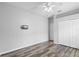 This bedroom features ample closet space, wood-look flooring and a mounted TV at 213 Strathmore Cir, Kissimmee, FL 34744