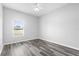 Bedroom features a window with wood look flooring at 213 Strathmore Cir, Kissimmee, FL 34744
