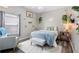 Bright bedroom with a bed, chair and window at 213 Strathmore Cir, Kissimmee, FL 34744