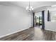 Dining area features sliding glass doors, dark curtains, and wood-look floors at 213 Strathmore Cir, Kissimmee, FL 34744