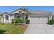 Charming single-Gathering home with a well-manicured lawn and a two-car garage at 213 Strathmore Cir, Kissimmee, FL 34744