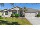 Charming home with a well-manicured front yard, featuring a two-car garage and tasteful landscaping at 213 Strathmore Cir, Kissimmee, FL 34744