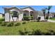 Charming single-story home featuring a well-maintained lawn, lush landscaping, and a decorative fountain at 213 Strathmore Cir, Kissimmee, FL 34744