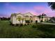 Charming single-story home with lush lawn, palm trees, and attractive landscaping at 213 Strathmore Cir, Kissimmee, FL 34744