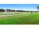 Scenic golf course view with lush green grass and meandering path, perfect for a relaxing day of golfing at 213 Strathmore Cir, Kissimmee, FL 34744