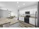 Spacious kitchen features granite countertops, stainless steel appliances and lots of natural light at 213 Strathmore Cir, Kissimmee, FL 34744