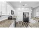 Updated kitchen with stainless steel refrigerator and granite counters at 213 Strathmore Cir, Kissimmee, FL 34744