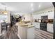 Open kitchen featuring granite countertops, modern black appliances, and white cabinets at 213 Strathmore Cir, Kissimmee, FL 34744