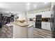 Bright kitchen with granite countertops, white cabinets, and modern appliances at 213 Strathmore Cir, Kissimmee, FL 34744