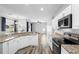 Open kitchen with granite counters, stainless appliances, and hardwood floors at 213 Strathmore Cir, Kissimmee, FL 34744