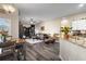 Open-concept living space with a cozy seating area, kitchen bar, and modern flooring at 213 Strathmore Cir, Kissimmee, FL 34744