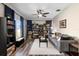 Inviting living room with modern ceiling fan, plank flooring, and well-stocked bookshelves at 213 Strathmore Cir, Kissimmee, FL 34744