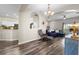 An open concept home with an archway to the living room featuring wood-look floors and natural light at 213 Strathmore Cir, Kissimmee, FL 34744